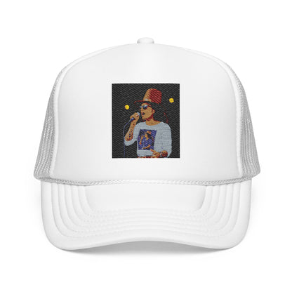 White trucker cap with embroidered design of a person wearing a hat and sunglasses on a white background